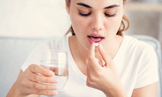 Woman taking a pill