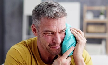 man with a cold compress