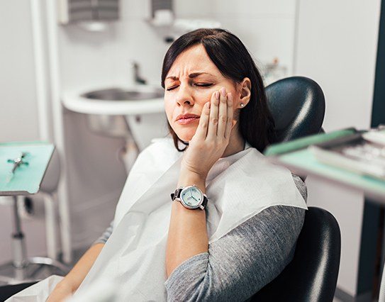 Woman in dentistry treatment room for emergency dental visit