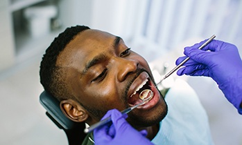 a dentist examining a patient’s teeth