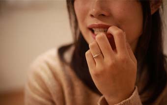 a person biting their fingernails