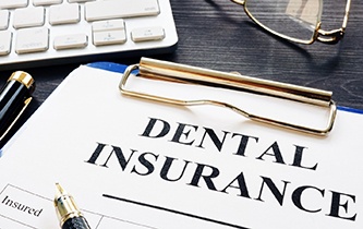 a dental insurance claim form on a clipboard