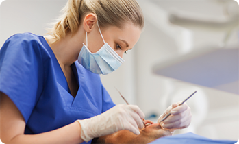 Female dentist performing a dental cleaning