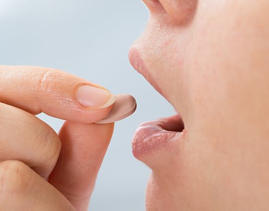 Patient taking oral conscious sedation dentistry pill