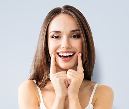 Woman showing offer her smile after cosmetic dentistry