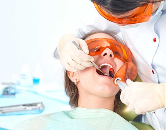 dentist in Little Rock placing a tooth-colored filling