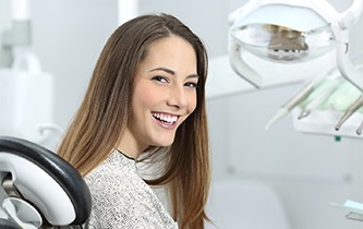 Woman with veneers in Little Rock smiling at dentist office 