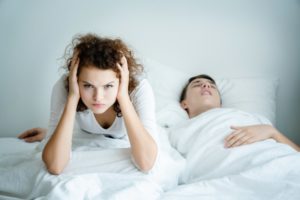 woman upset at her partner’s snoring