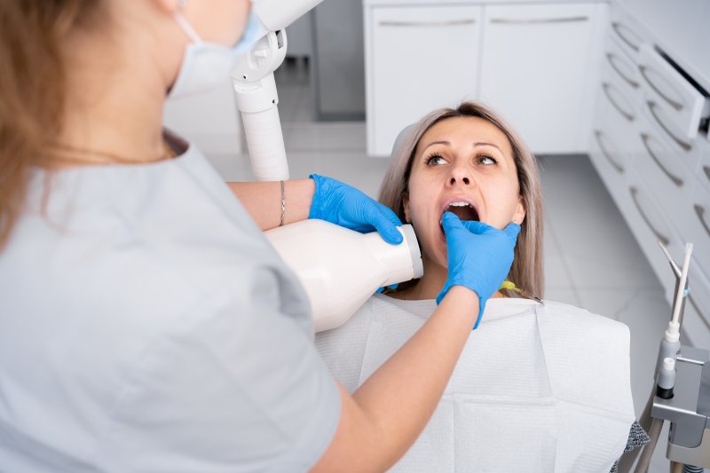dentist taking X-rays of patient 