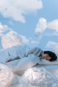 Woman sleeping on clouds