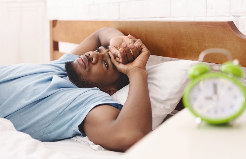 Man with sleep apnea lying awake in bed
