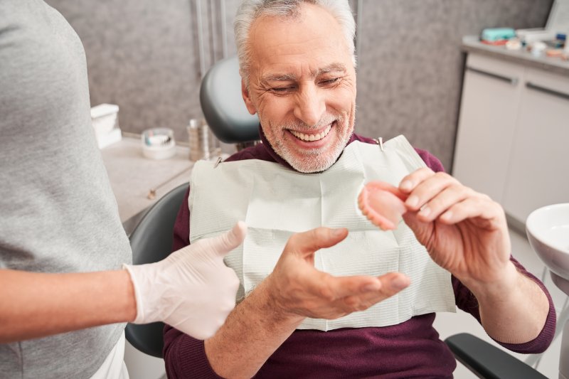 A man getting his dentures for the first time
